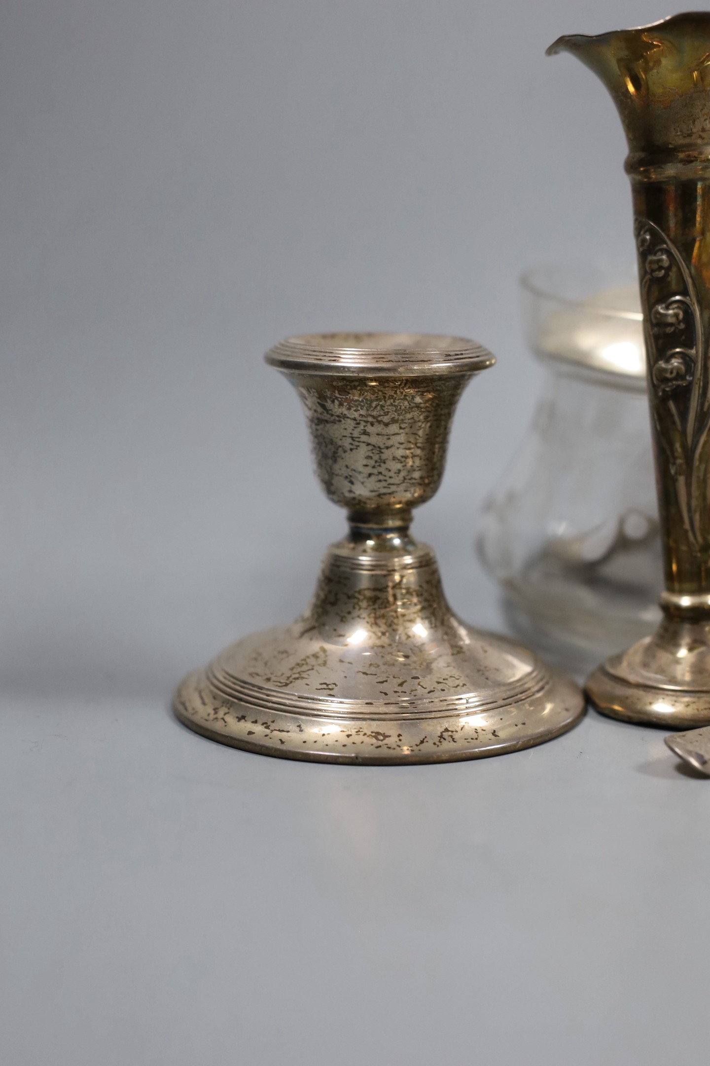 A collection of eighteen small pieces of silver and white metal items, including a silver topped glass preserve jar, trophy cup, flatware, napkin ring, trinket box, etc.